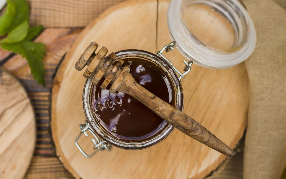 top-view-glass-jar-full-honey-with-honey-spoon